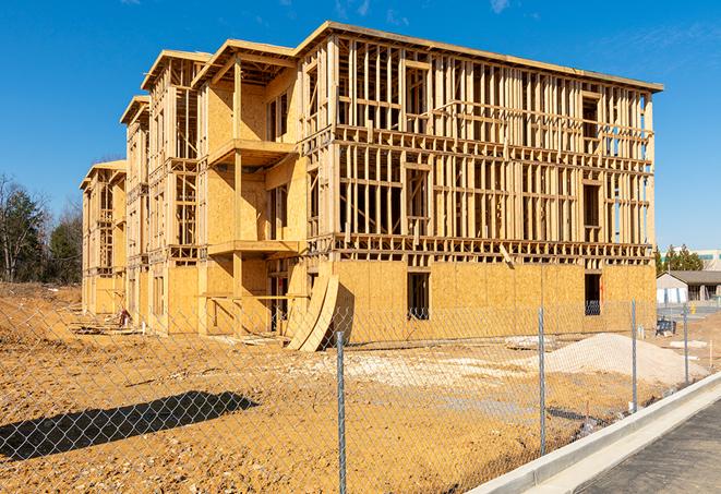 a close-up of temporary chain link fences enclosing a construction site, signaling progress in the project's development in Little Rock AR